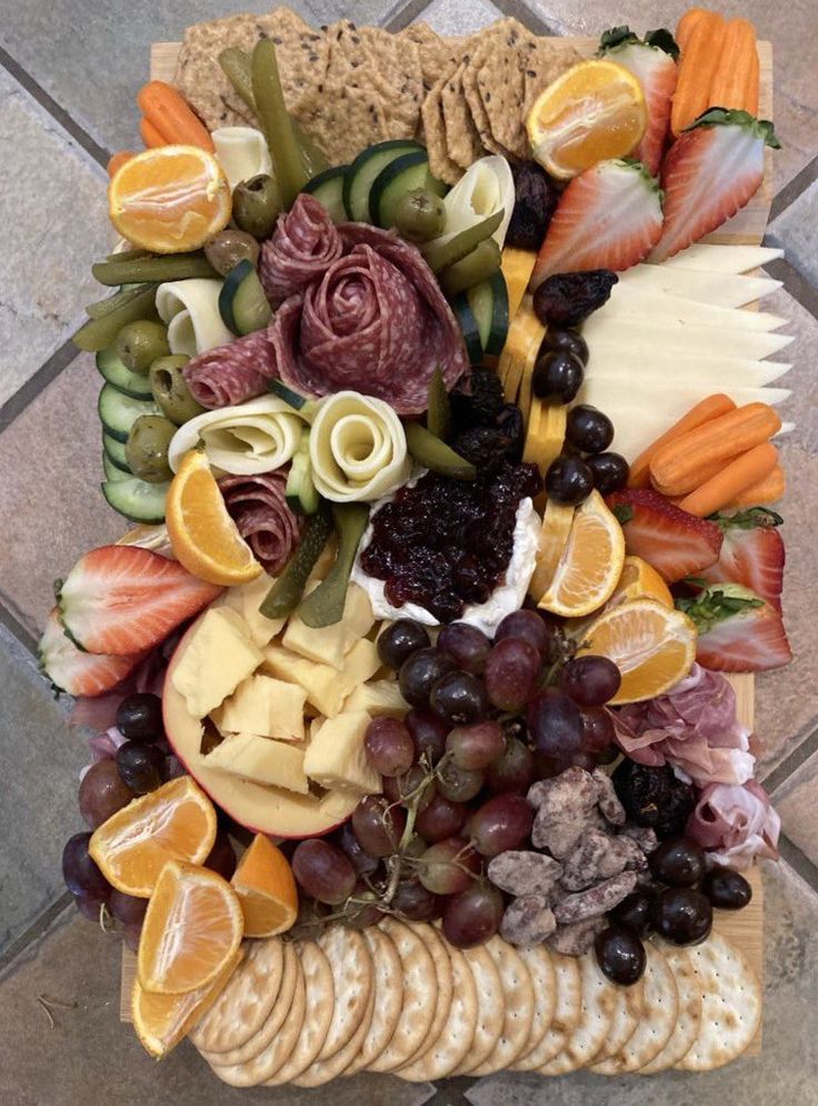 Charcuterie board with meats, cheeses, and fruit
